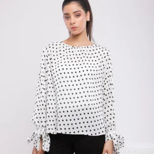 BLOUSE À POIS ET NOEUDS AUX POIGNETS